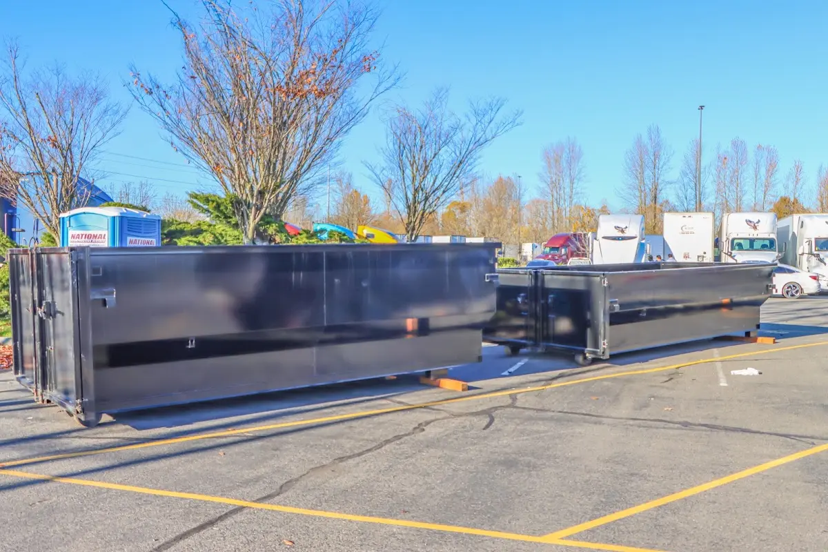 Professional dumpster rental service with roll-off container on residential driveway in Pasadena